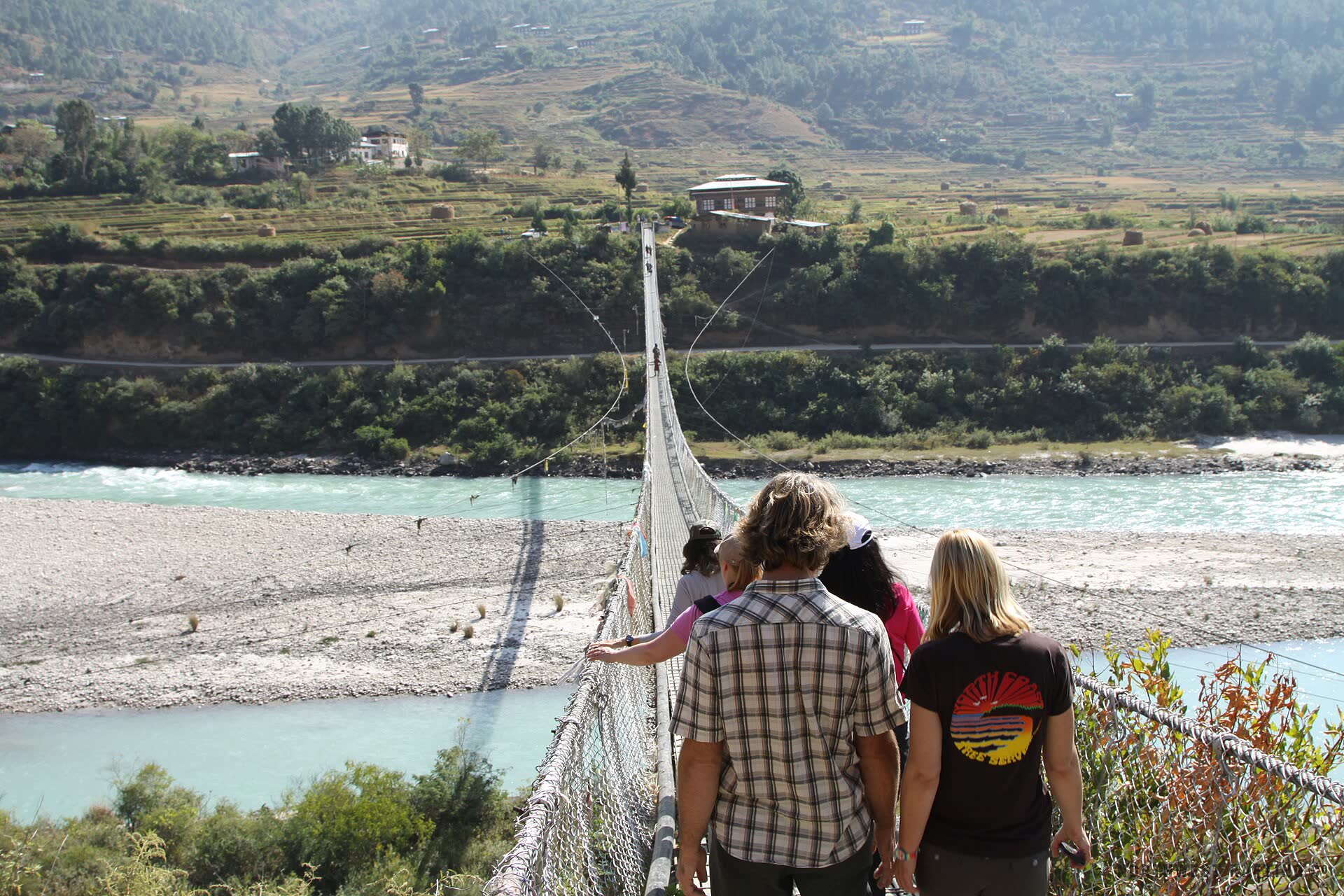 Travellers crossing the Punakha suspension bridge
